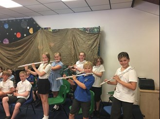 The pupils of Haresfield Primary playing flutes
