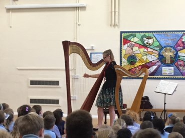 A photo of Natasha Gale performing on her harp