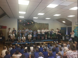 A group of pupils of Haresfield Primary performing with their woodwind instruments to the other students and teachers